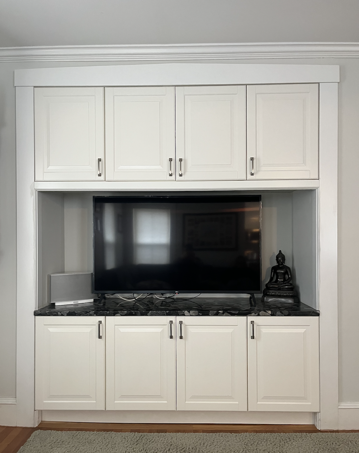 Custom built-in TV cabinetry with granite countertop