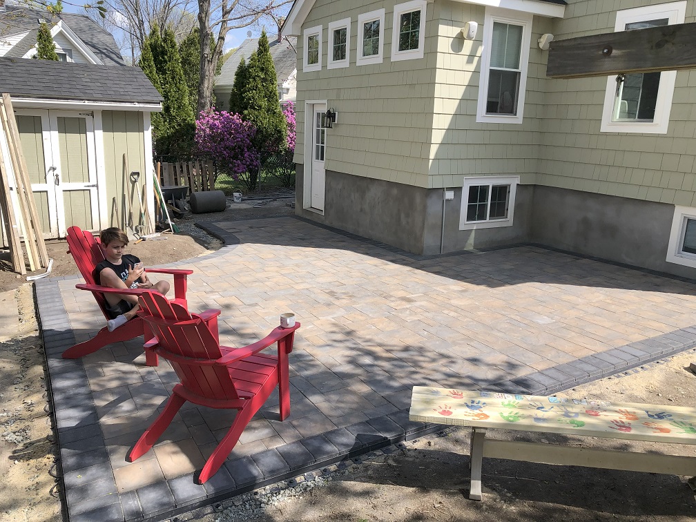 Finished paver patio with Adirondack chairs