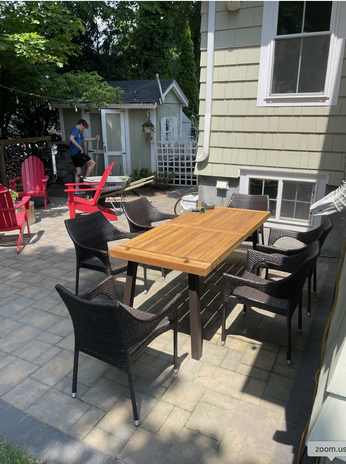 Finished patio with outdoor dining table and Adirondack chairs
